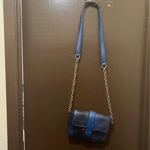 Blue crossbody purse. Dark blue with gold chain straps